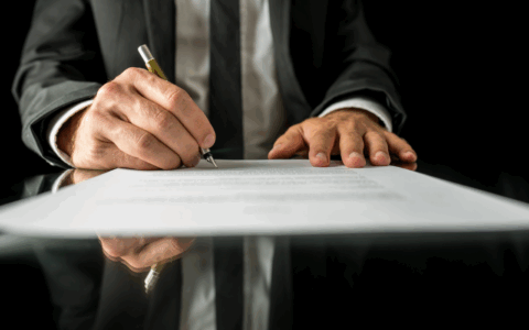 a man writing his signature