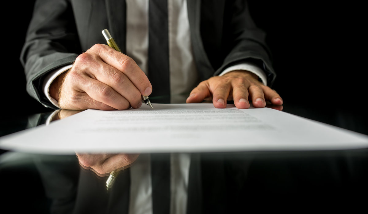 a man writing his signature
