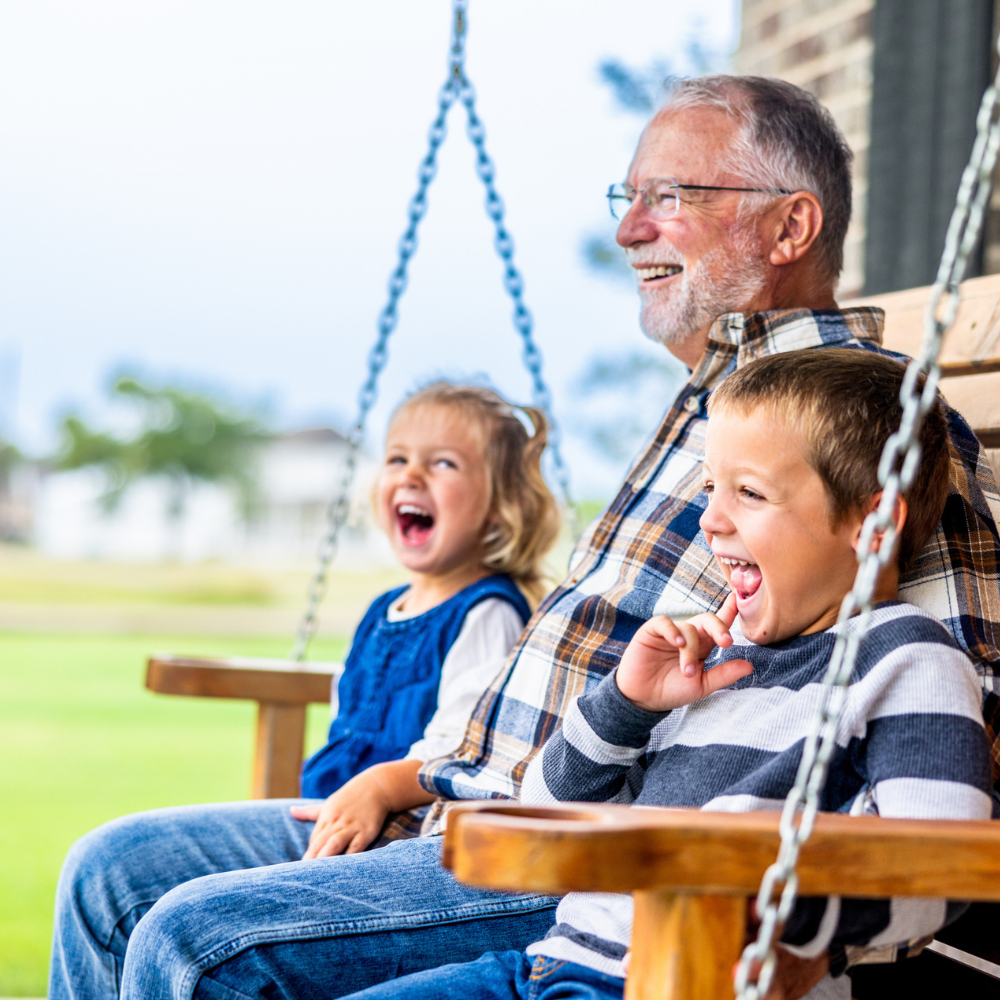 a grandfather and his grandkids smiling