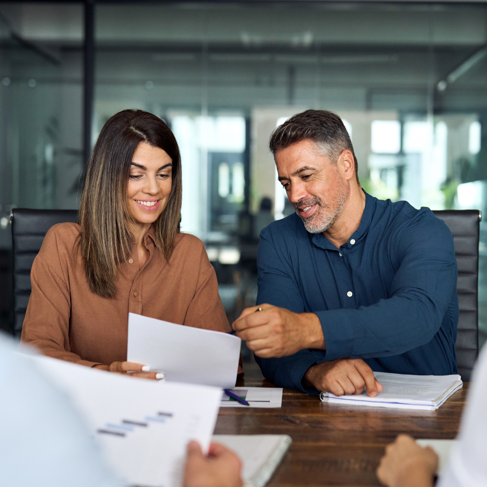a couple happy together while looking at the paper