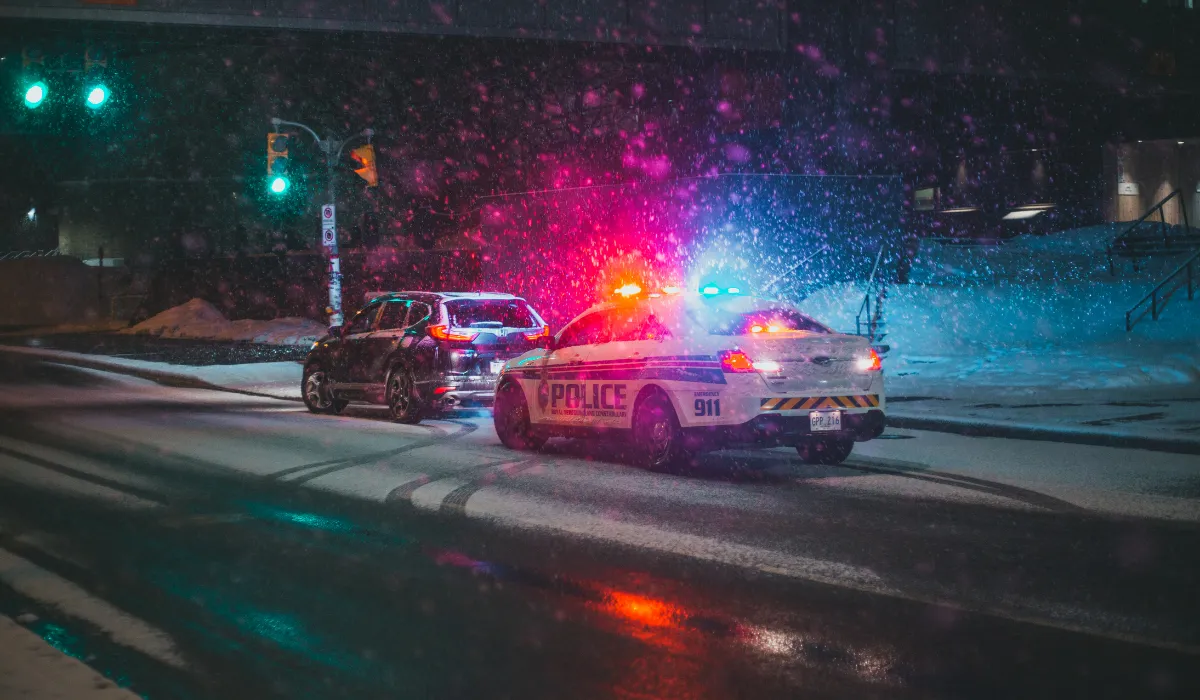 Police cruiser with flashing lights at night, impaired driving defence